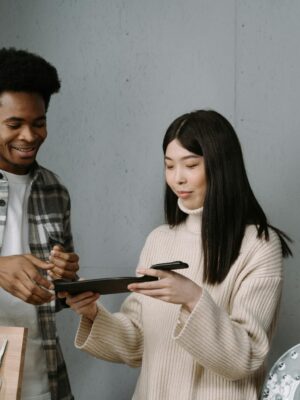 A man and woman engaged in a sales discussion over tableware in a modern store.